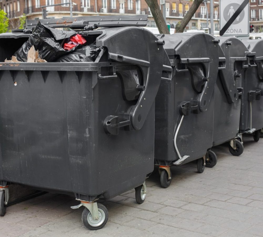 Black plastic dumpster. Street large garbage containers